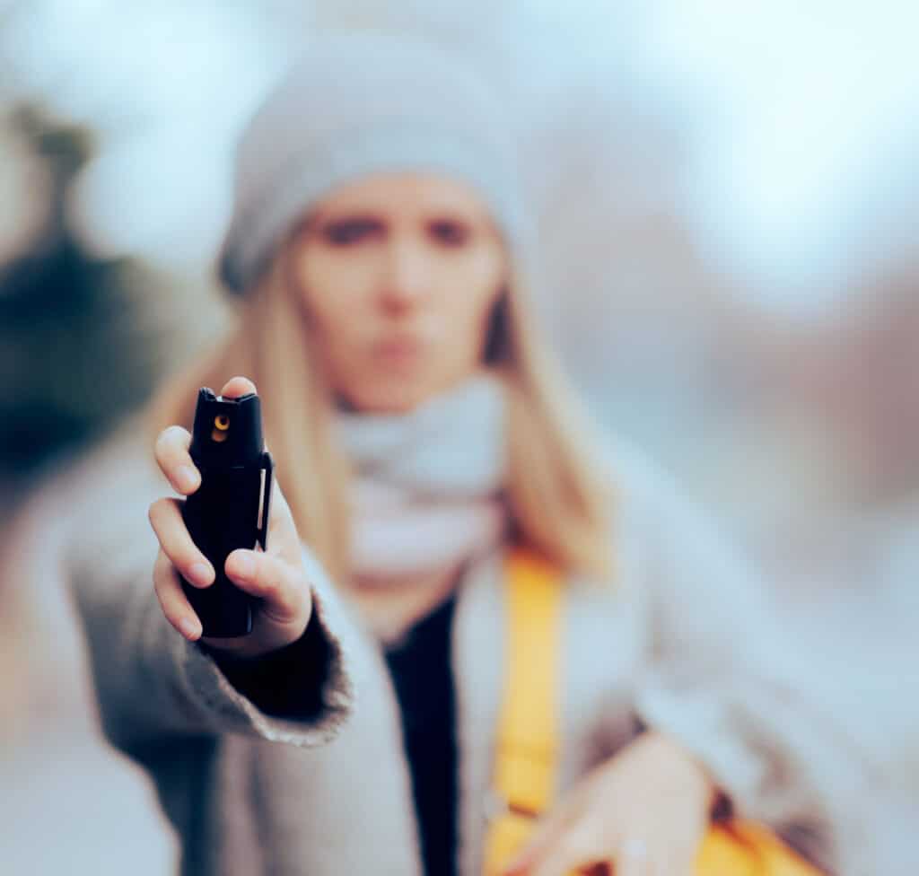 woman holding pepper spray