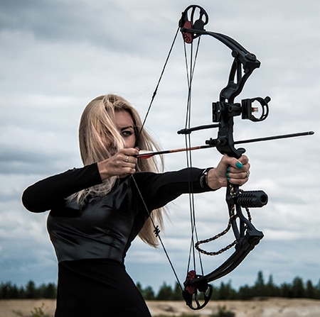 Woman shooting compound bow